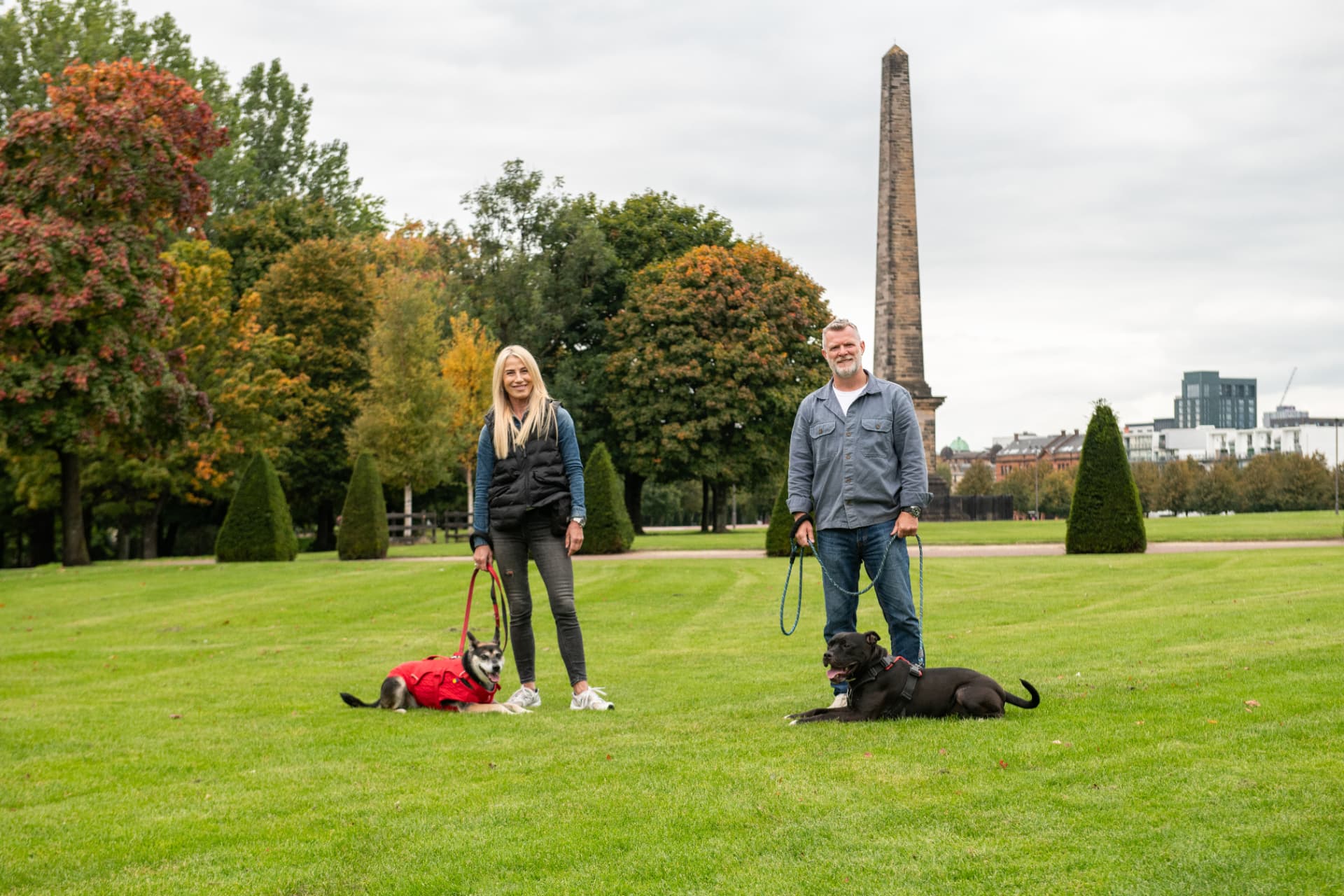 Glasgow dog trainers John McGuigan and Helen Hutcheson working with two dogs in a park