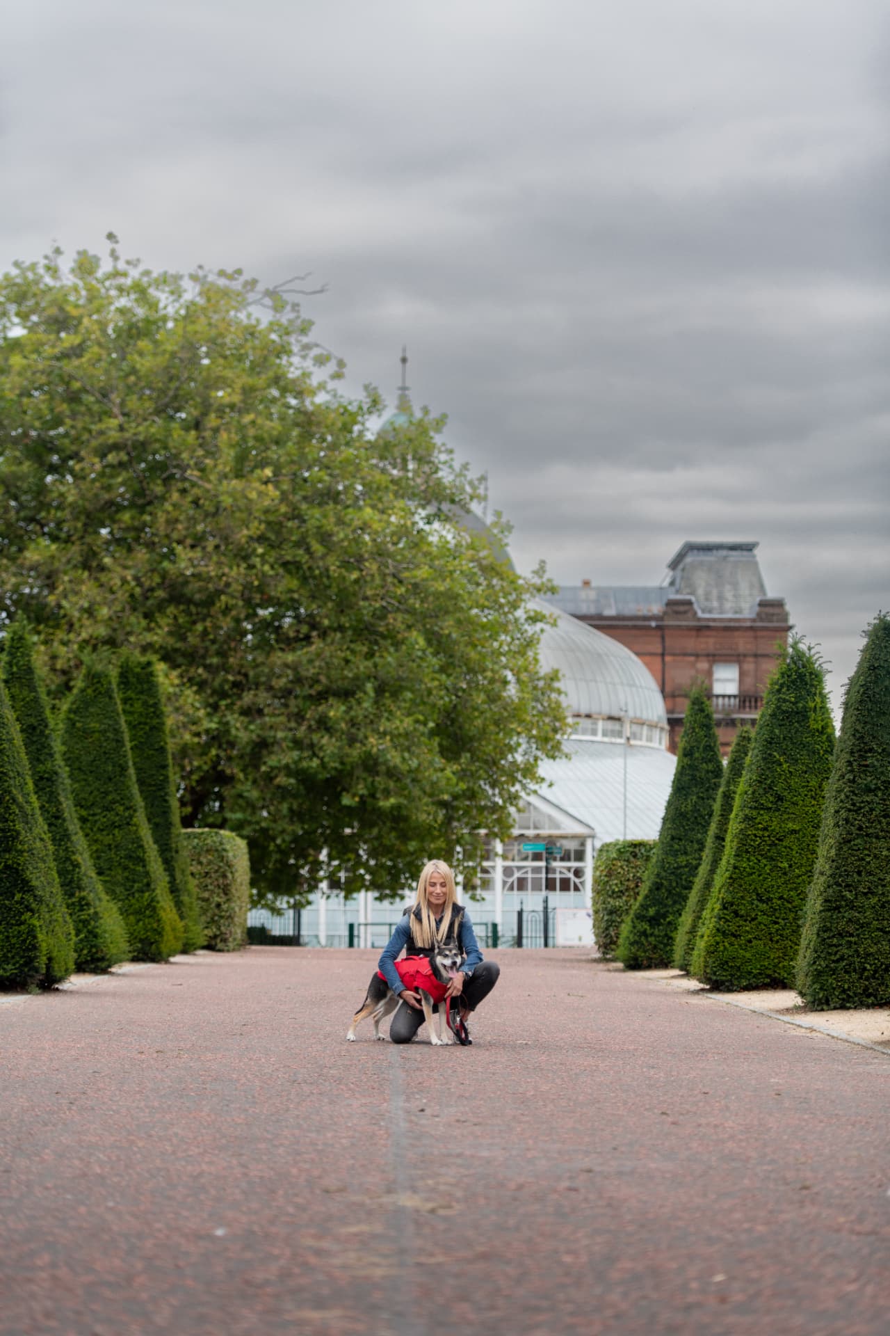 Helen Hutcheson kneeling to reward a young dog during a Glasgow training session