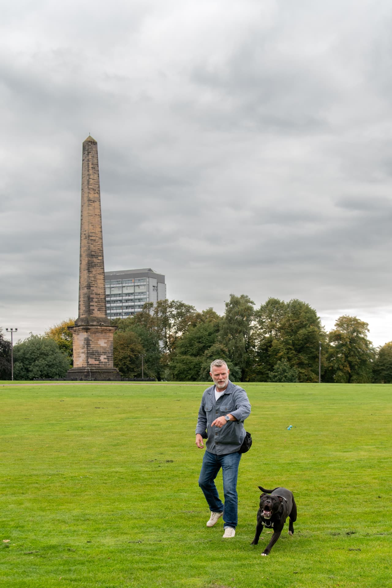Calm lead walking beside a Glasgow monument during a behaviour session