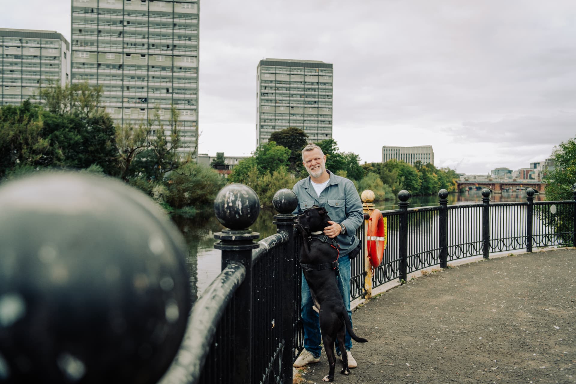 Lead-walking practice along a riverside railing in Glasgow