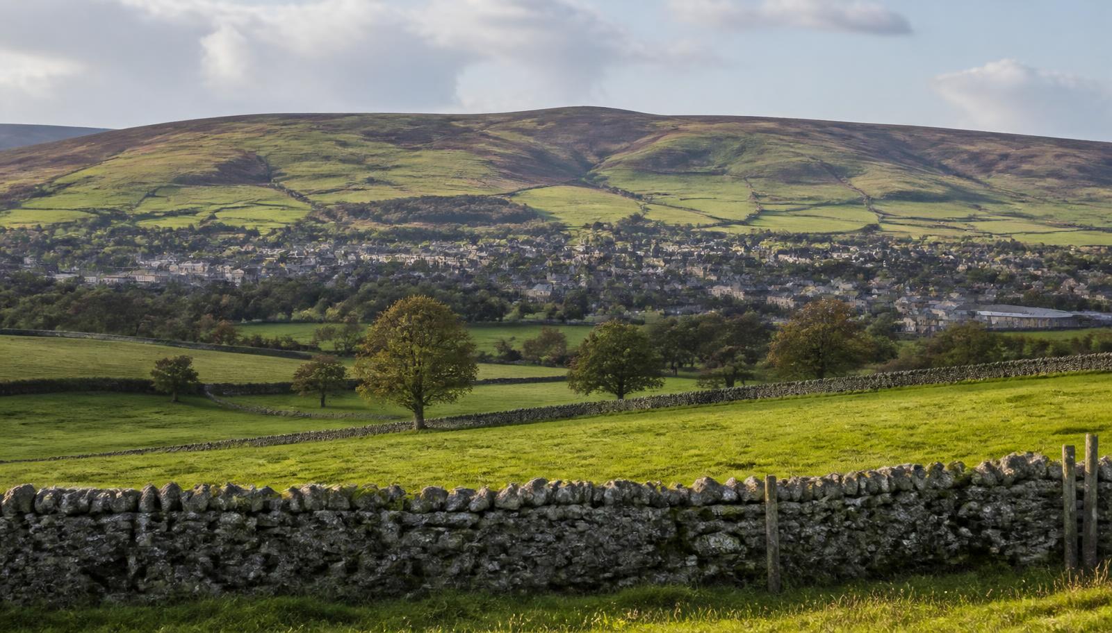 East Ayrshire farmland with dry stone dykes and a town below moorland hills