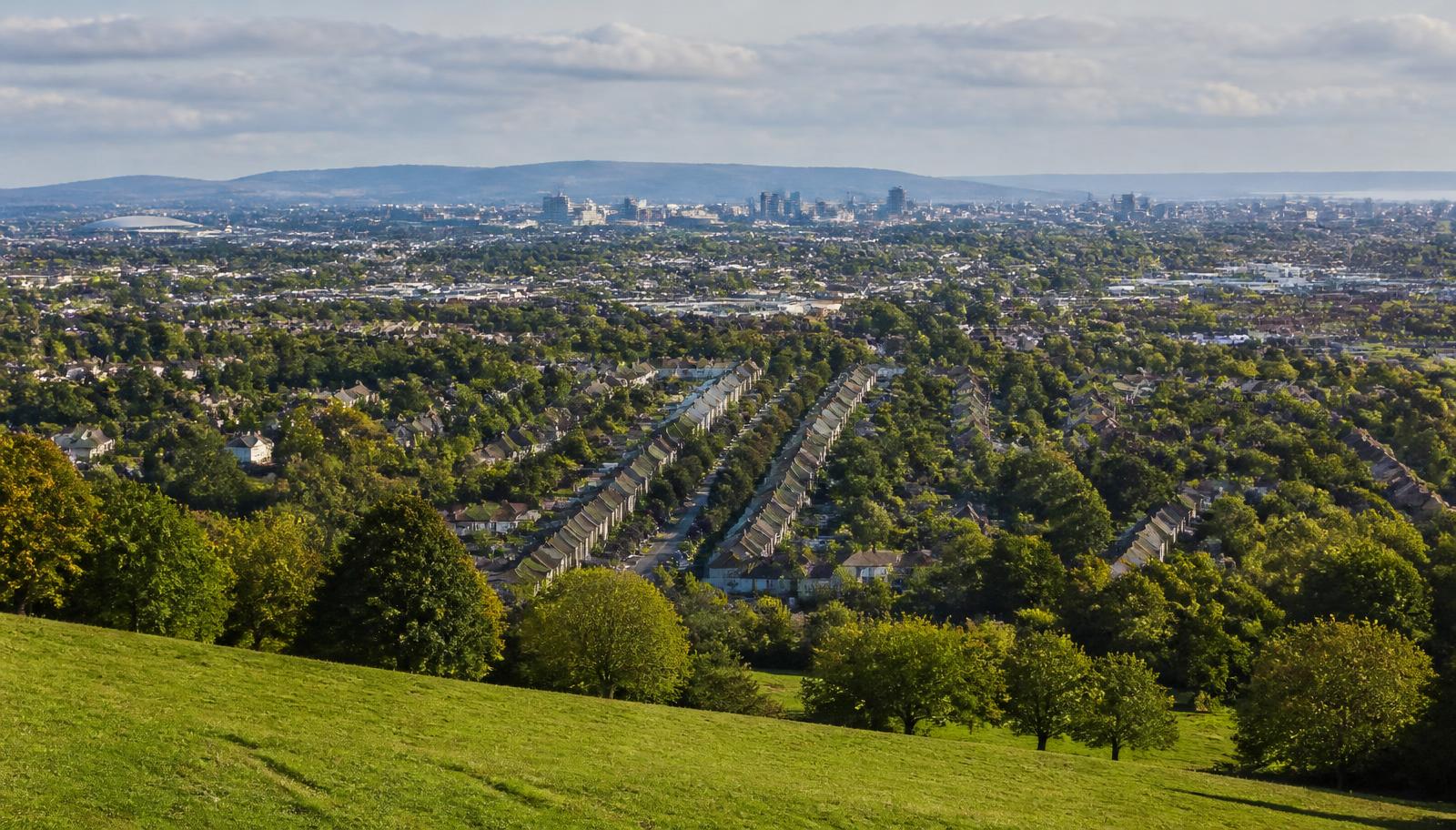 Greater Glasgow suburbs and tree-lined streets seen from a hillside park